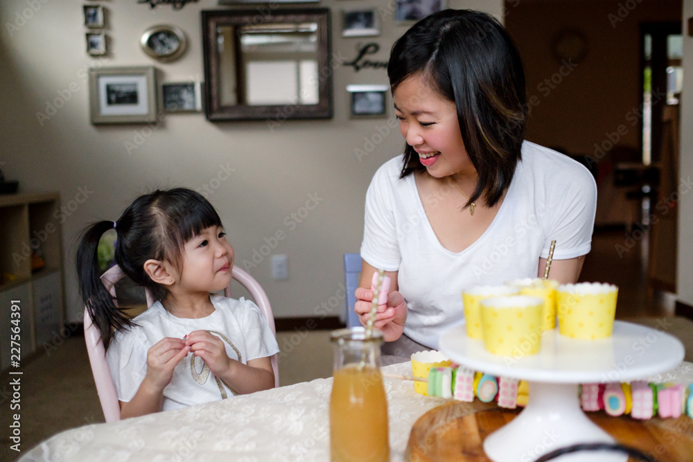 Asian Mother Eating Marshmallow Together at Home Asian Mother Eating Marshmallow Together at Home
