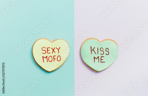 pale valentine candy cookies with messages over pastel background