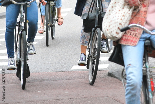 Amsterdam women riding their bikes to work. photo