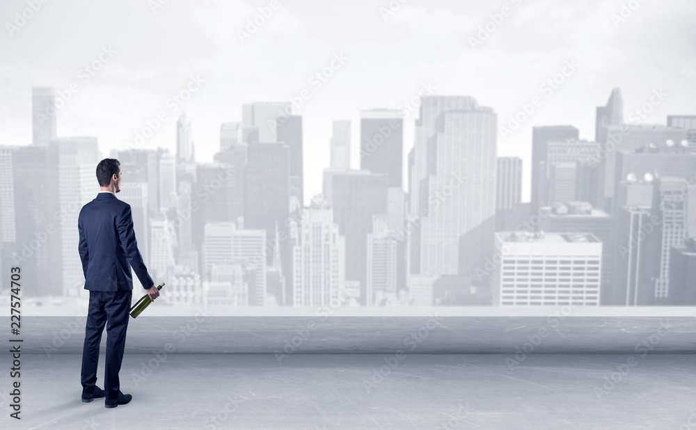 Businessman standing with his back on a roof with objects in his hand
Businessman standing with his back on a roof with objects in his hand