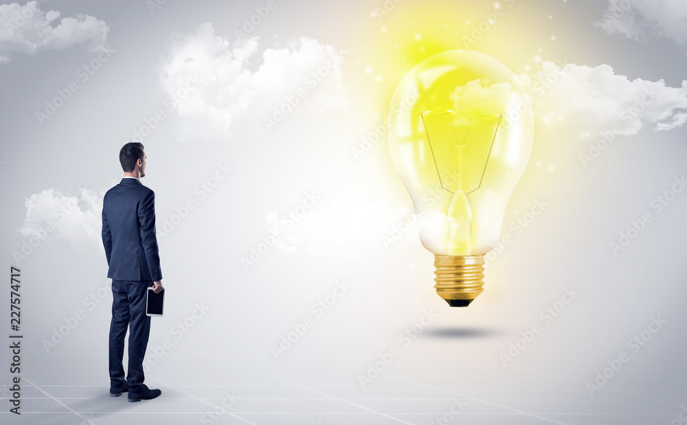 Businessman standing with his back with objects in his hand and looking at the globe, courtesy of NASA
