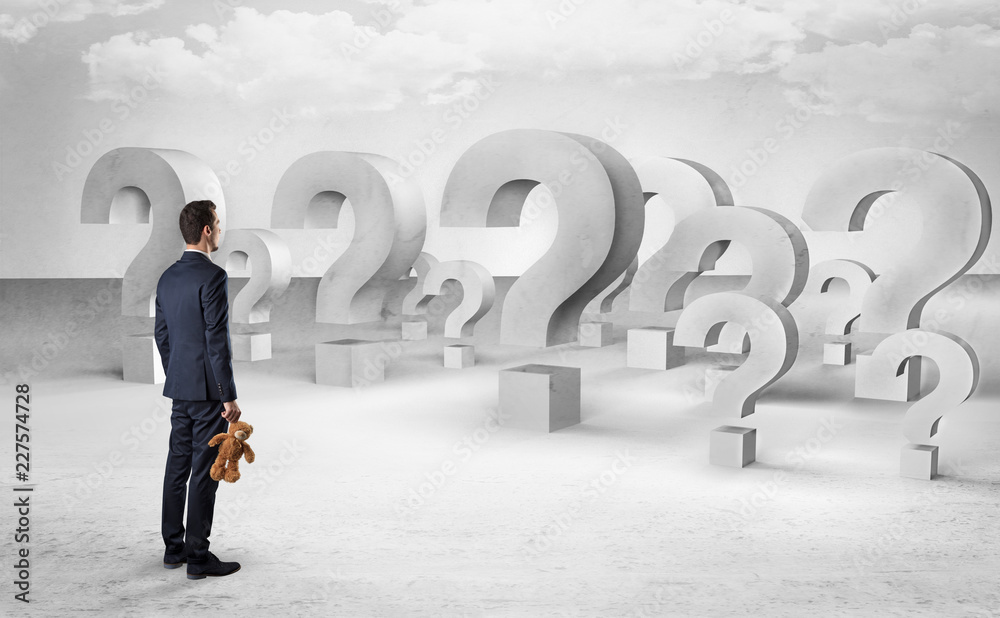 Businessman standing and looking to a bunch of question mark signs
Businessman standing and looking to a bunch of question mark signs