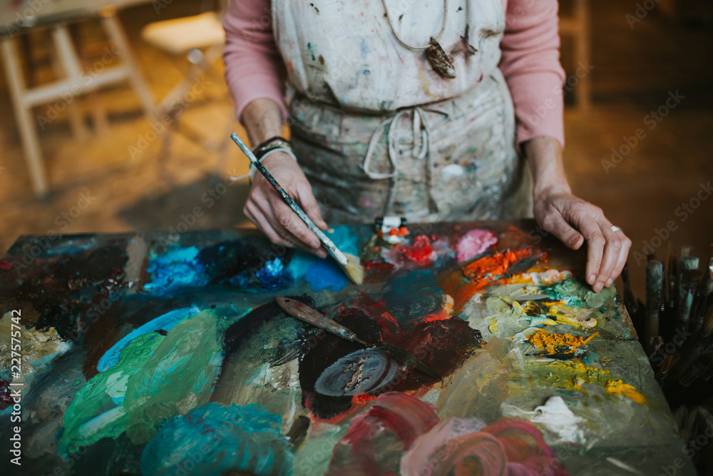 Woman painting in her art studio Woman painting in her art studio