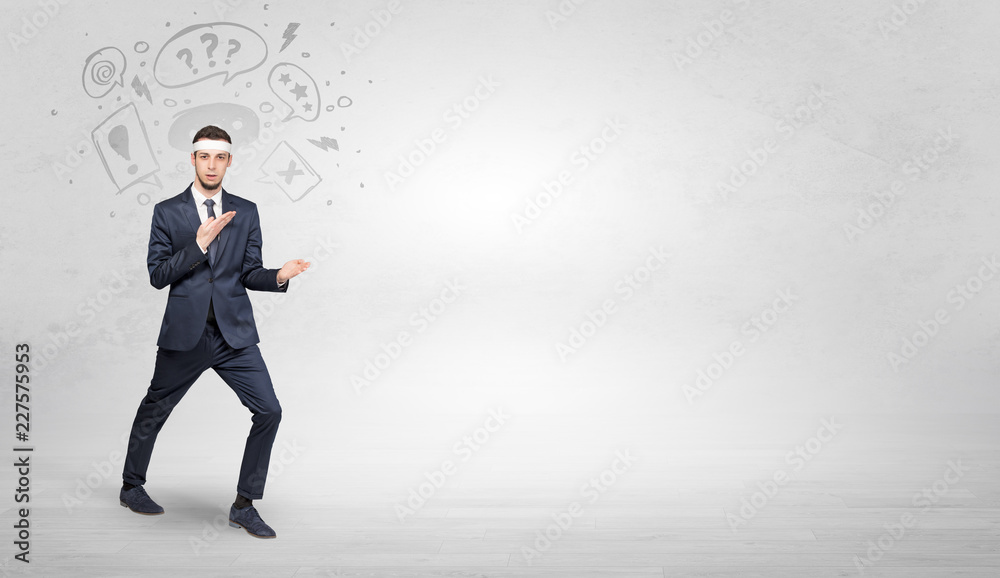 Young businessman in suit fighting with doodled symbols concept
Young businessman in suit fighting with doodled symbols concept