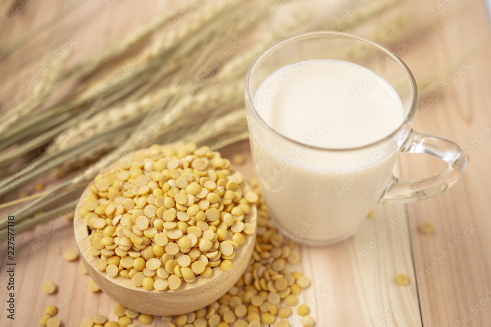 Glass of soy bean milk views from top with split soy bean on barley wheat and wo Glass of soy bean milk views from top with split soy bean on barley wheat and wo