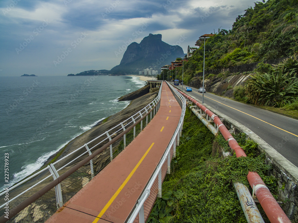 Highway by the sea and bike path. Asphalt road beside the sea. Car advertising background. 