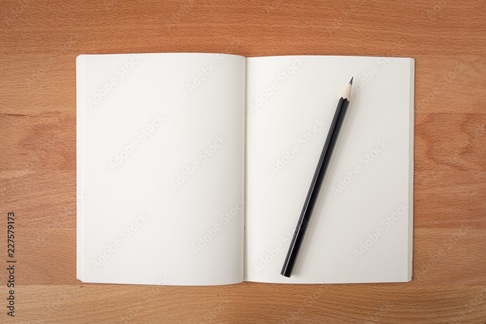 Top view open notebook white pages with pencil on wood texture desk background Top view open notebook white pages with pencil on wood texture desk background