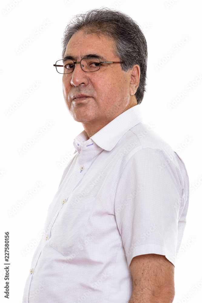 Studio shot of senior Persian man profile view Studio shot of senior Persian man profile view