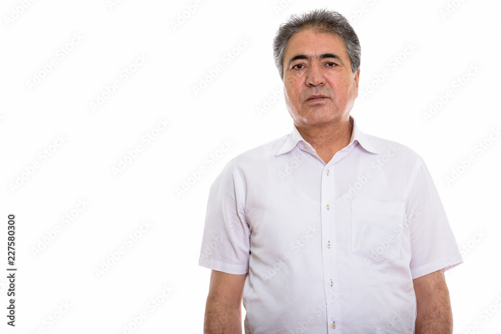 Studio shot of senior Persian man standing Studio shot of senior Persian man standing