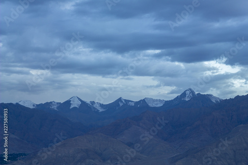 cold sky over mountain snowy peaks in the evening © Pavel