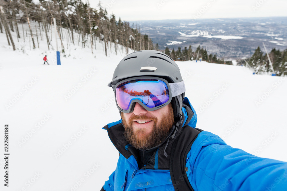 Bearded man pauses to take a selfie while skiing down a mountain Bearded man pauses to take a selfie while skiing down a mountain