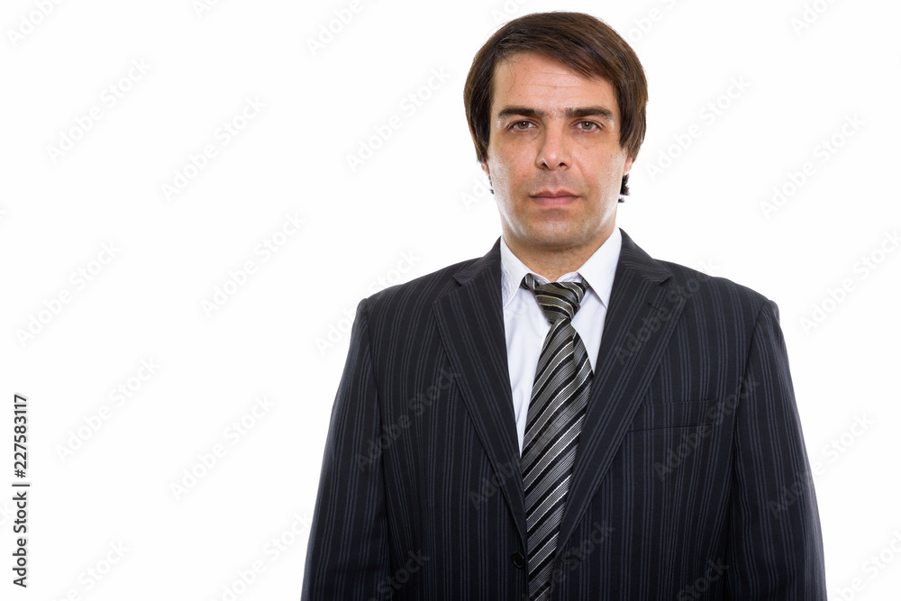 Studio shot of young Persian businessman standing Studio shot of young Persian businessman standing