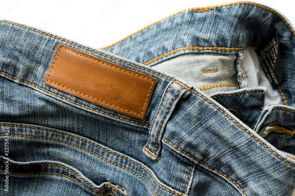 Blue jeans pants with back pocket and empty brown leather tag