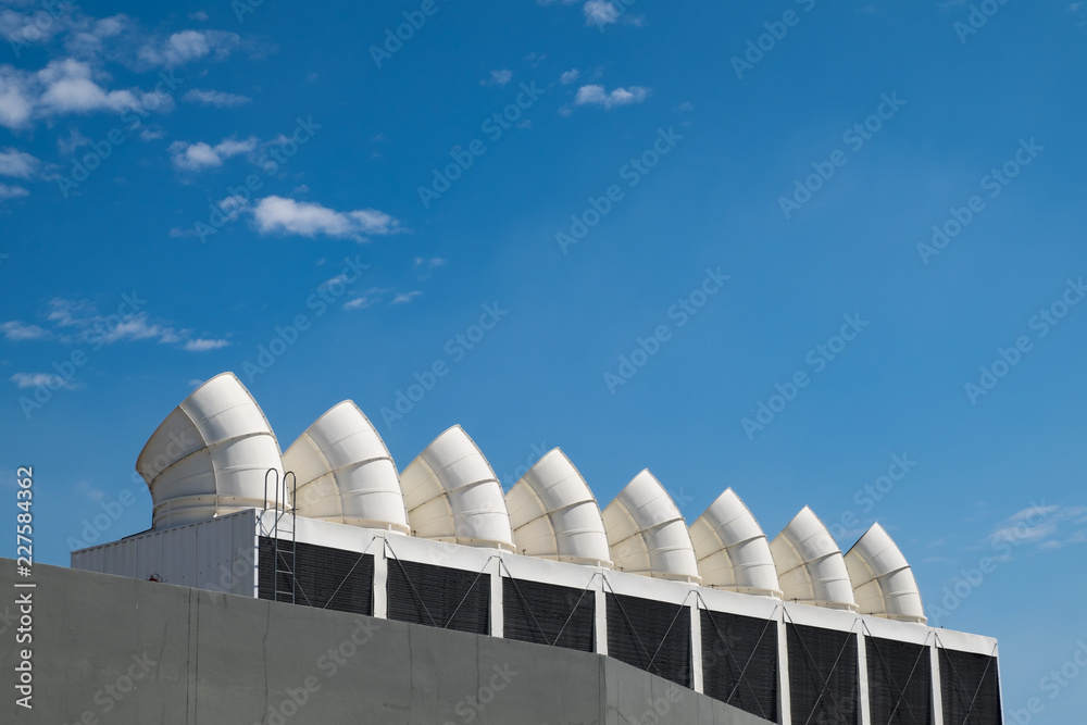 Row of industrial chiller air conditioner condenser units on rooftop ...