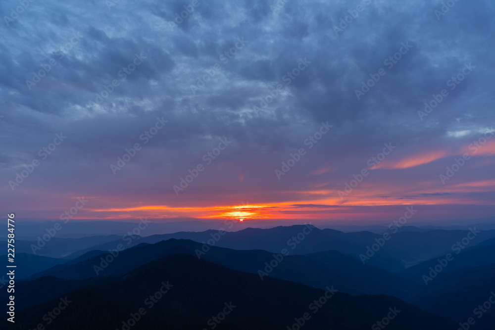 The picturesque sunset above mountain landscape The picturesque sunset above mountain landscape