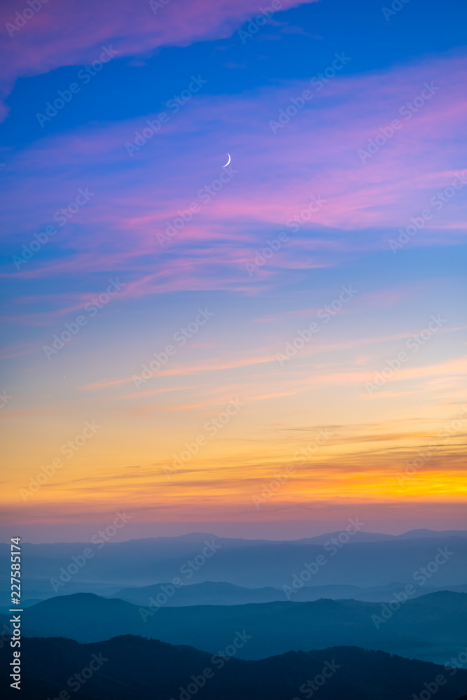 The picturesque mountain landscape on the sunrise background