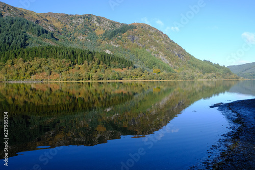 Reflections of autmumn colours in the waters of Loch Lubnaig in the Scottish Highlands
