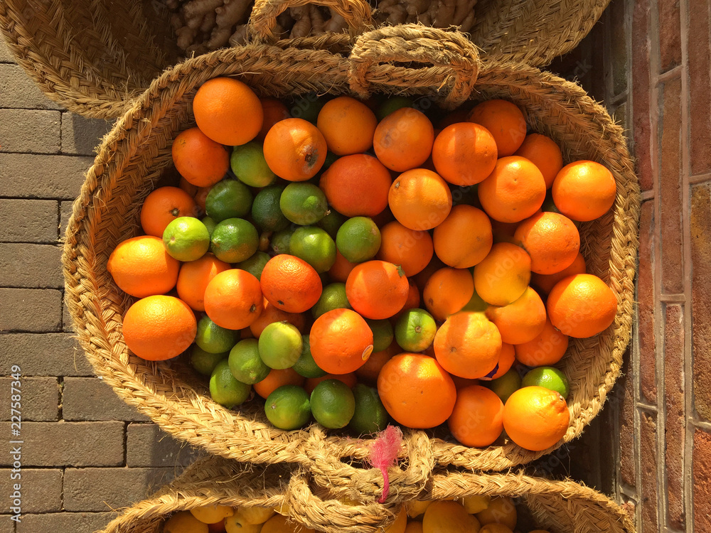 a basket with oranges and limes a basket with oranges and limes