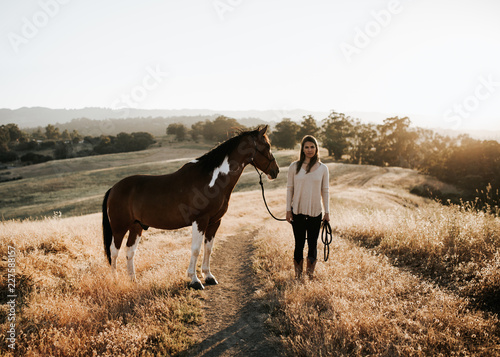 Girl standing with horse