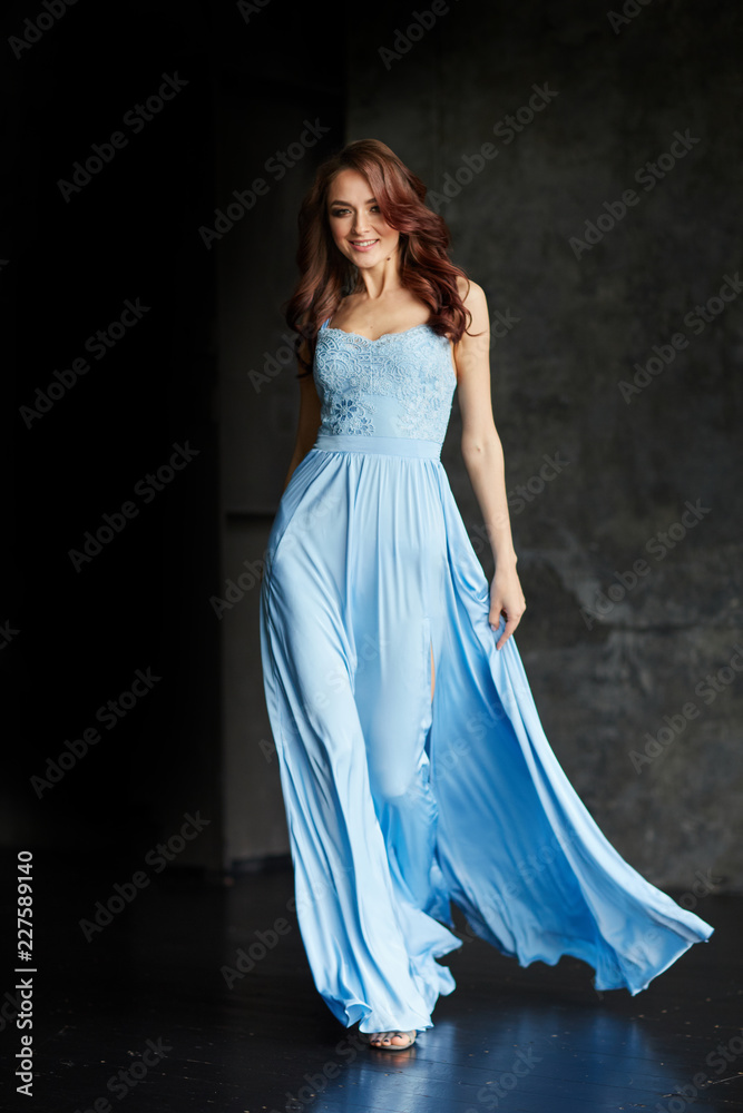 Beautiful girl with make up and hair in long blue dress Beautiful girl with make up and hair in long blue dress