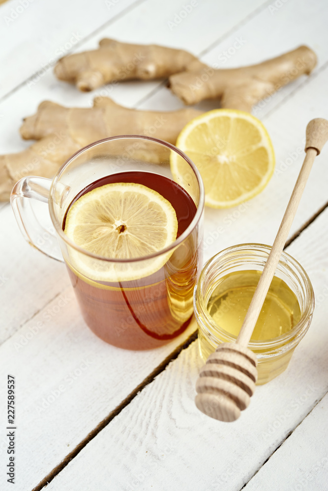 delicious hot tea with lemon on an old white wooden table with ginger and honey delicious hot tea with lemon on an old white wooden table with ginger and honey
