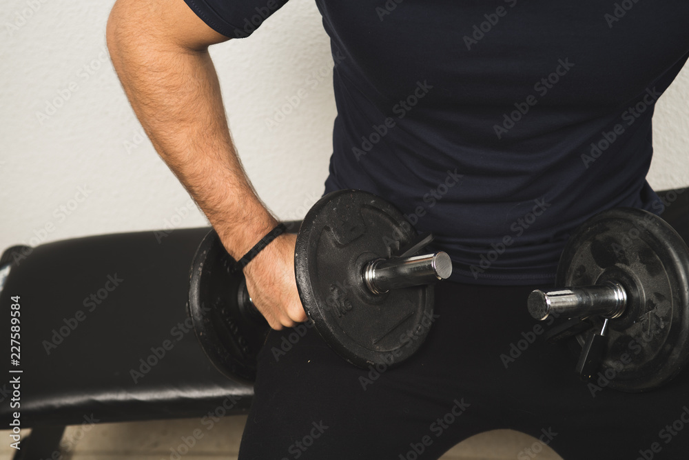 Man exercising with dumbbells, dumbbell exercise to stay Man exercising with dumbbells, dumbbell exercise to stay