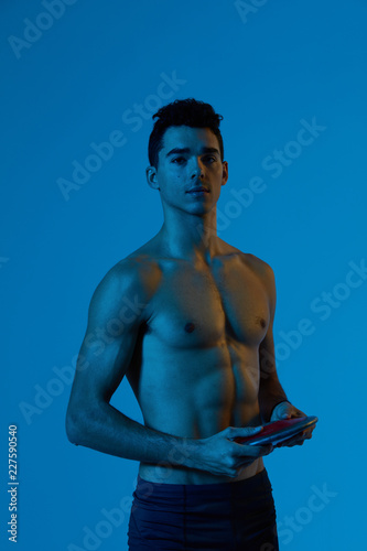 Athlete standing with disc in studio photo