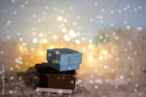 Christmas and New Year background. Boxes with Christmas gifts in candlelight. The concept of warm and cozy winter holidays.