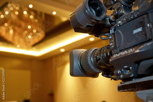 Professional digital video camera. accessories for 4k video cameras. tv camera in a concert hall. Video camera lens - recording show in TV studio - focus on camera aperture