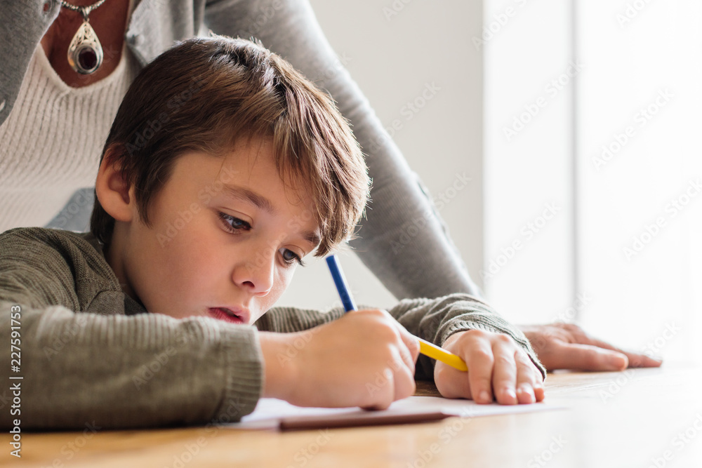 Little boy painting with his grandmother at home. Little boy painting with his grandmother at home.