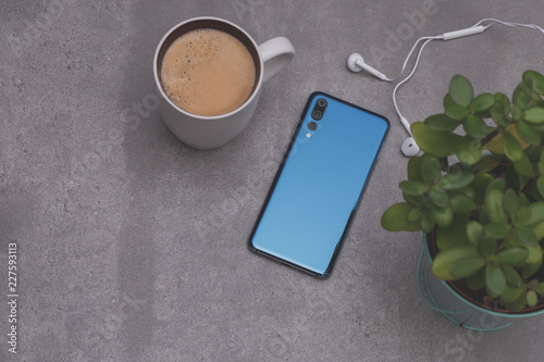 New design smartphone lay near coffee cup. Coffee time concept.