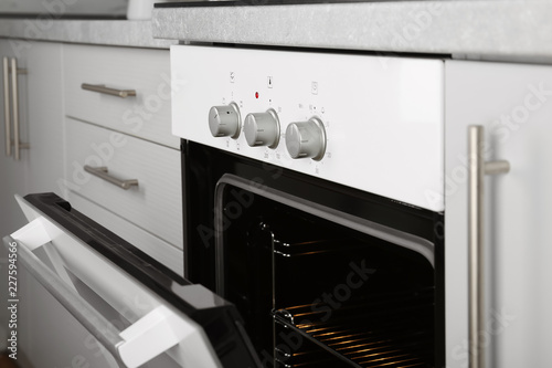 Open empty electric oven in kitchen, closeup