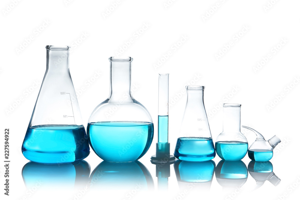 Laboratory glassware with liquid on table against white background. Chemical analysis Laboratory glassware with liquid on table against white background. Chemical analysis