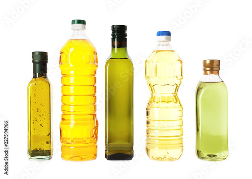 Bottles with different oils on white background