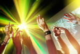 Party concept with hands and light rays