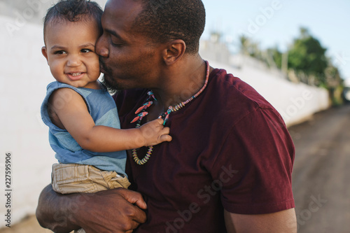 Young dad enjoying son outside on sunny day photo