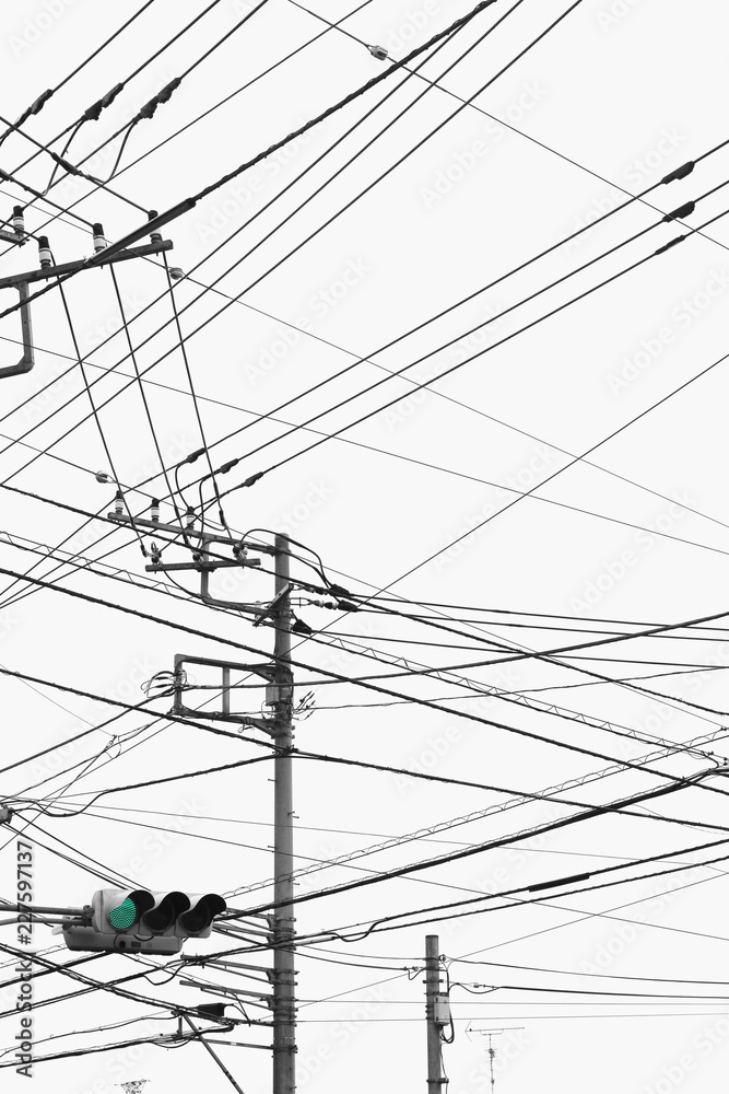 green light, power lines, power poles and cloudy sky green light, power lines, power poles and cloudy sky