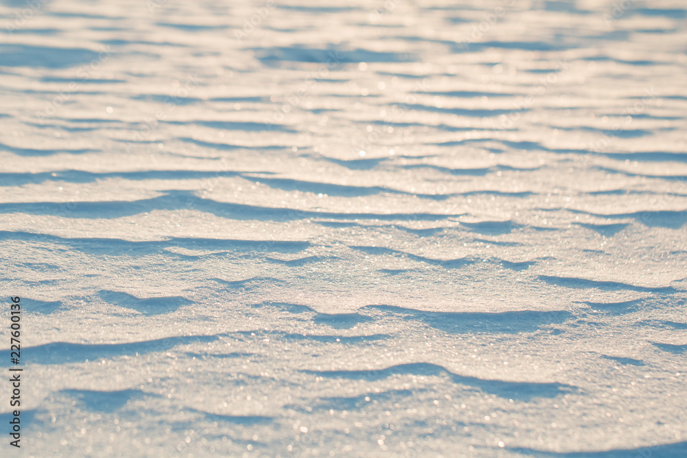 Close up view on frozen waves on a snow at sunset. Winter background. Close up view on frozen waves on a snow at sunset. Winter background.