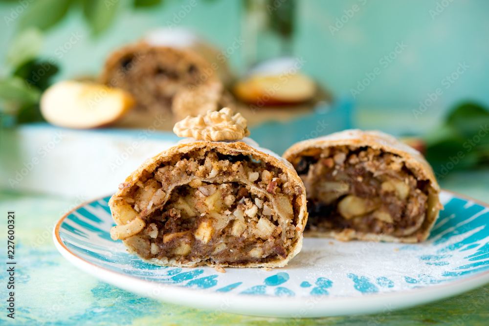 Apple strudel with raisins on a light background Apple strudel with raisins on a light background