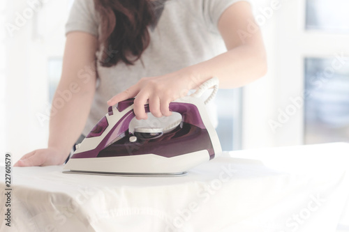 young girl stroking on an Ironing Board iron clothes