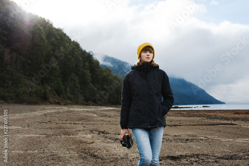 Portrait of a female photographer exploring a lake in Patagonia photo