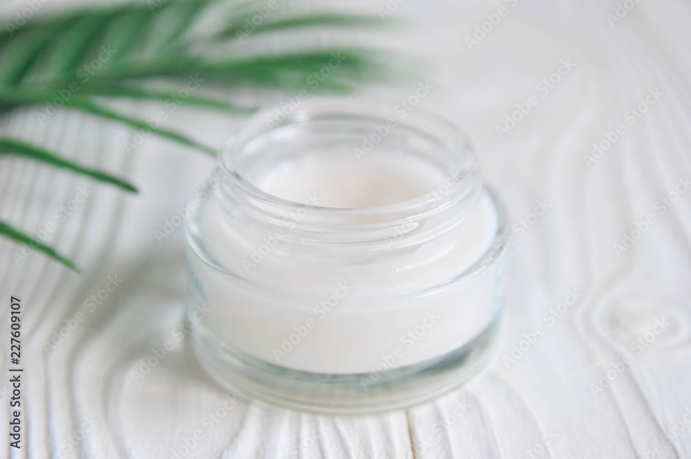 Natural and organic cosmetic concept. White cream in jar Natural and organic cosmetic concept. White cream in jar