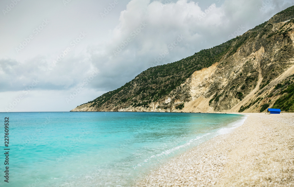 Turquoise sea water and huge rocks on Myrthos beach shoot after rain. Kefalonia island, Greece.