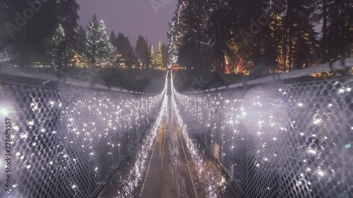 Long Suspension bridge decorated with Christmas lights, Rainy night photo