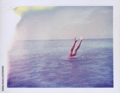 A Girl's Legs In A Summer Lake Photographed On Expired Polaroid Peel Apart Film photo