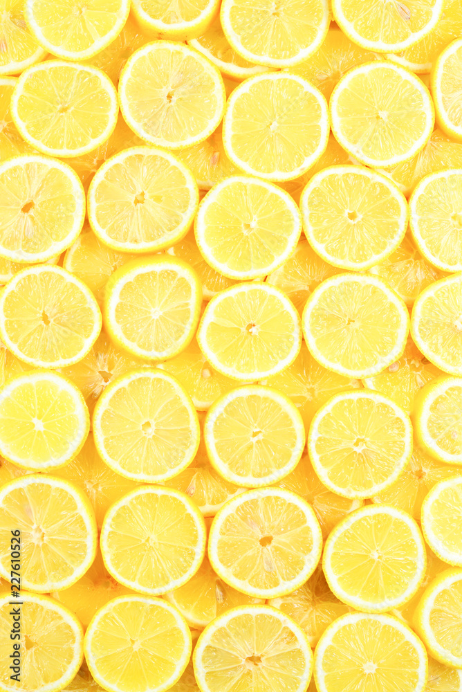 A slices of fresh juicy yellow lemons.  Texture background, pattern.