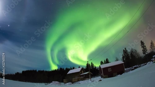 Northern lights dancing on a typical house in Norway.