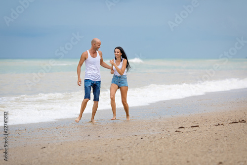 Family playing on wet sand in time of surf