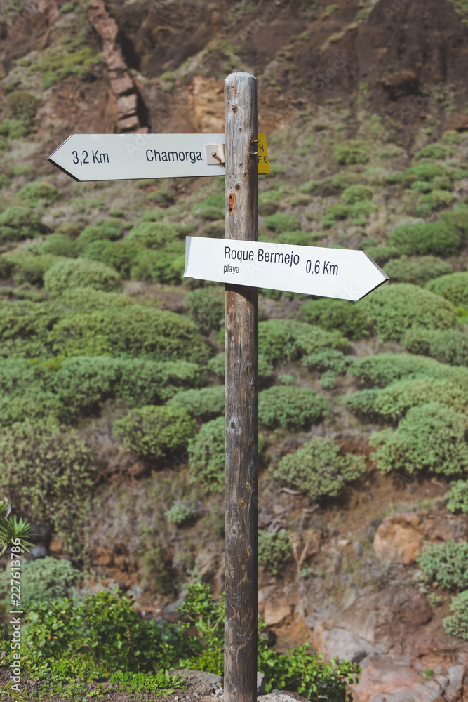 Wooden two arrow direction sign post in the mountains Wooden two arrow direction sign post in the mountains