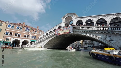 People looking Gondolas under the Rialto Bridge in Venice,during Venice Carnival